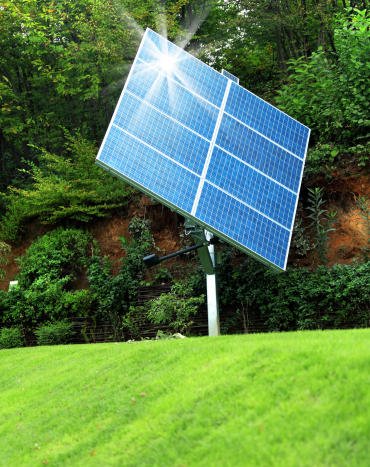 A solar panel on a green lawn, harnessing sunlight to generate clean energy.